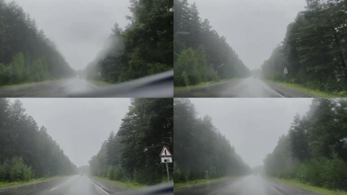 汽车在倾盆大雨中沿着高速公路行驶。慢动作视频。