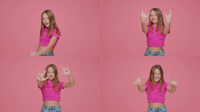 有趣快乐的儿童女孩用手展示摇滚手势，玩得开心。儿童摇杆在粉红色背景上制作死亡角标志