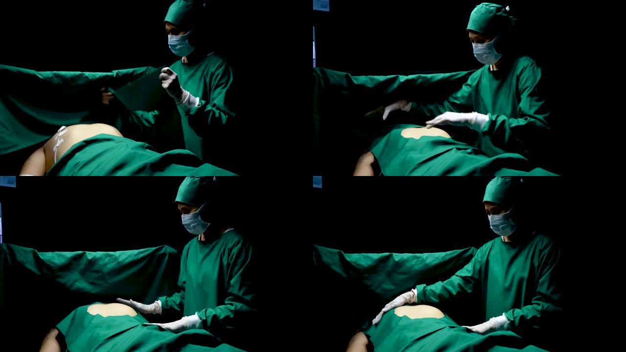 4K，患者因全身麻醉而昏迷不醒，为了准备通过手术进行药物治疗，医生使用绿色的布覆盖患者，仅覆盖需要手