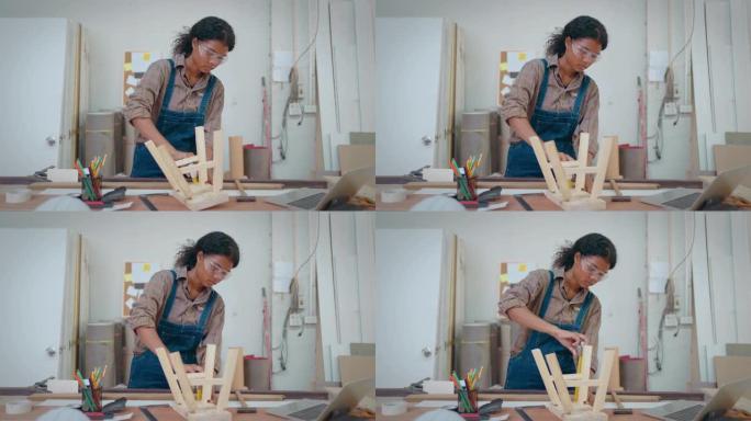 美丽的女人在木片上工作，用铅笔在木头上测量和标记。