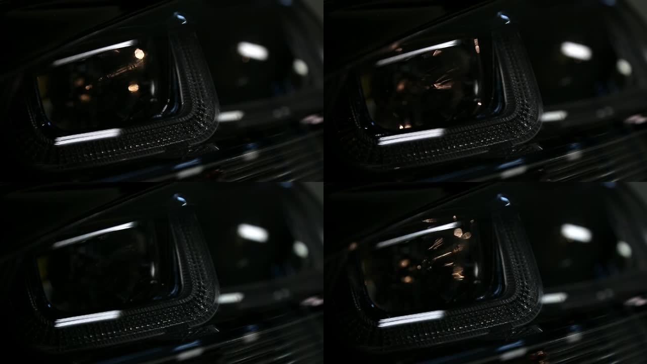 匿名著名的黑色豪华现代汽车前灯细节的特写。