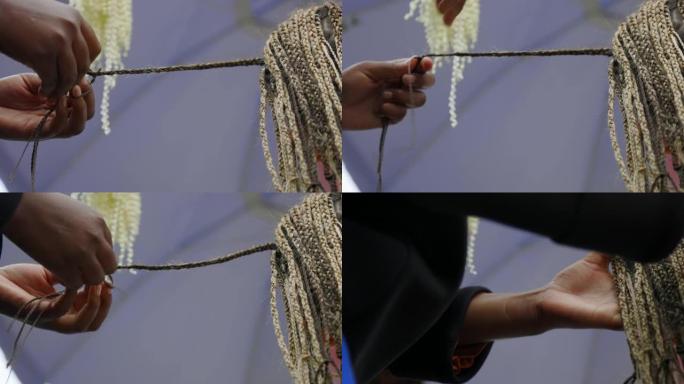 一个女人头上的许多辫子是由专业的黑人理发师编织的