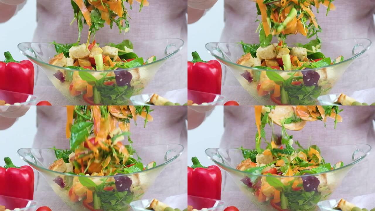 一个女人混合蔬菜沙拉的成分慢动作视频与掉落的生菜混合在玻璃板胡萝卜芝麻菜菠菜西红柿油炸红辣椒黄瓜素食
