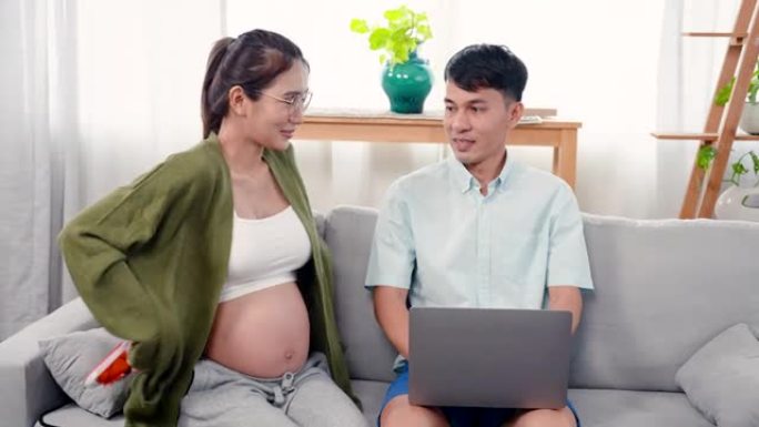 4K，丈夫坐在笔记本电脑上工作，严肃的脸，怀孕的妻子，大肚子走进去，抬起男孩的鞋子，说子宫里的孩子是