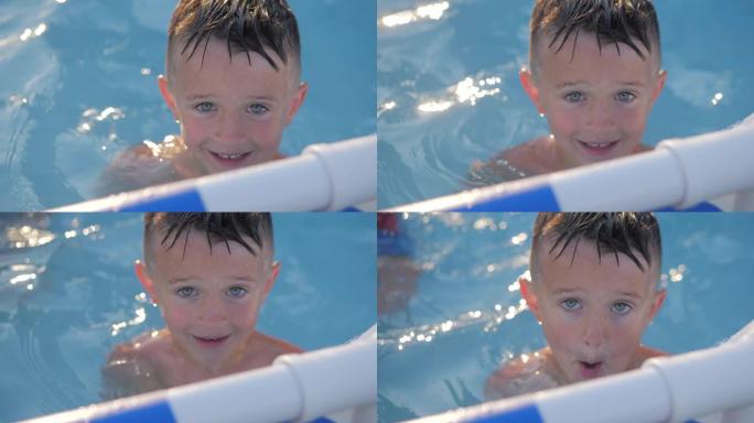 游泳池里的孩子微笑着。暑假期间，儿童男孩肖像对着镜头。