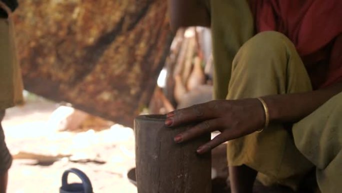 在埃塞俄比亚，一名妇女在杵中研磨并压碎煮熟的咖啡