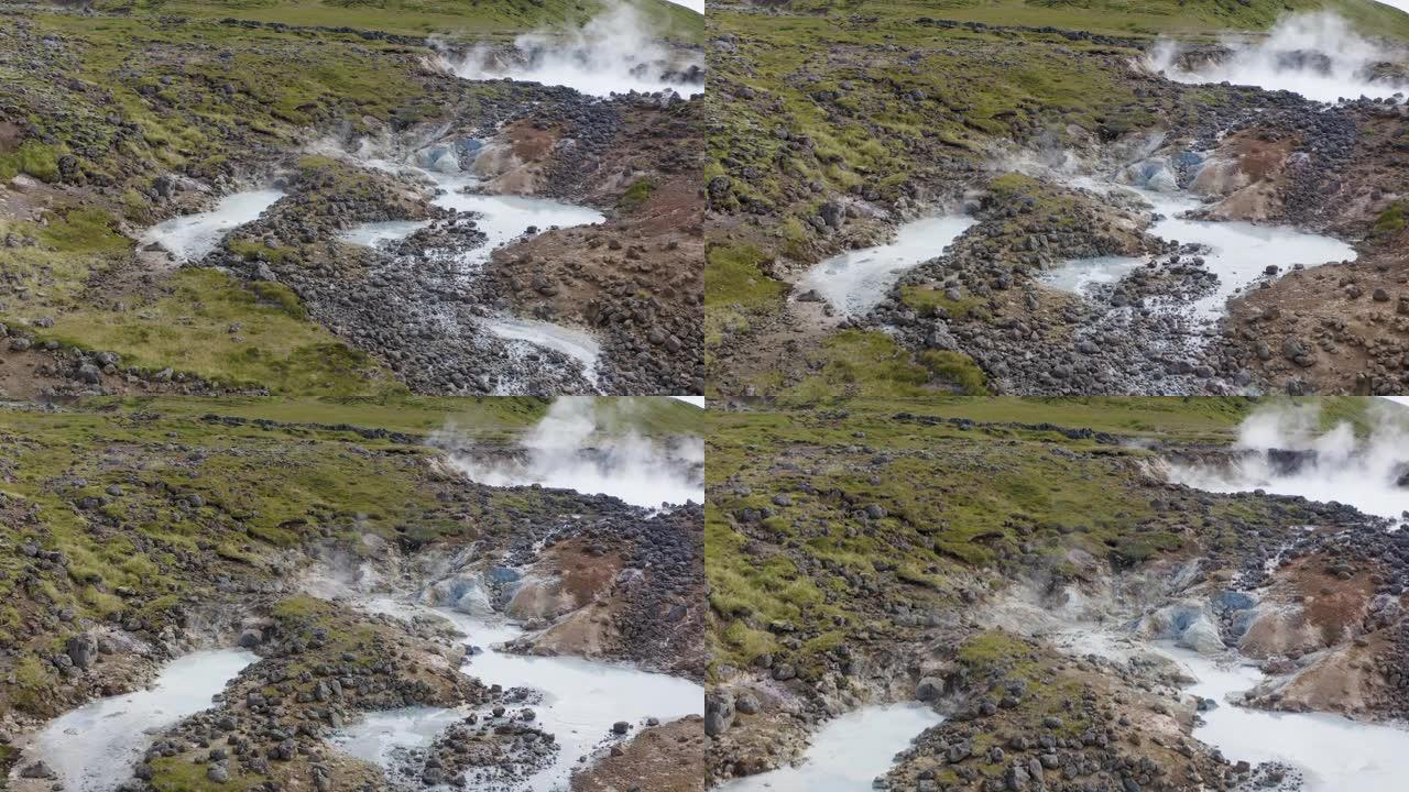 冰岛Olkelduhals地热区硫磺湖和泥罐的空中接近镜头-烟雾上升到天空