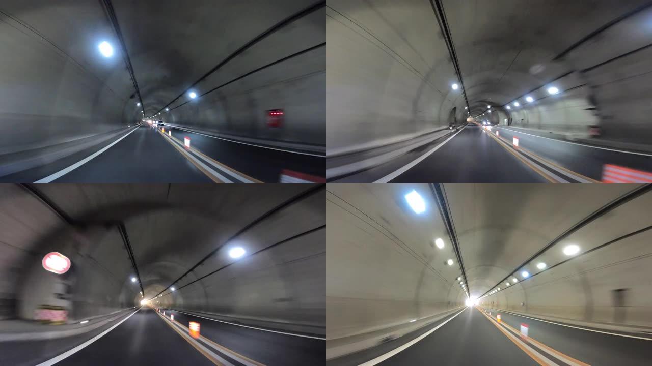 开车穿过高速公路。高速公路隧道入口。隧道尽头的光/高速