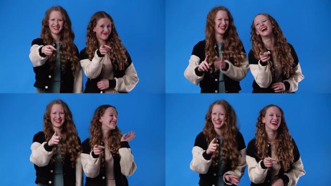 两个双胞胎女孩笑着看着镜头的4k慢动作视频。