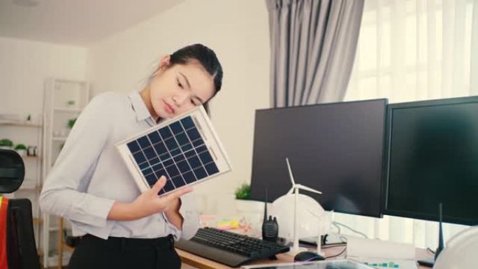 清洁能源电气工程师检查办公室内的太阳能电池板。