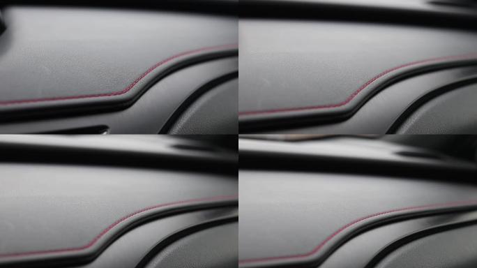 车辆内饰上面板上的红色缝线。仪表板装饰缝线。