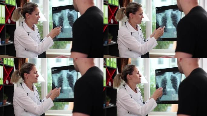 医生指向男性患者的肺部x射线损伤区域