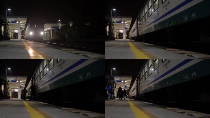 夜间列车进入车站并在站台停靠。旅客带着行李下来，前往车站大楼40