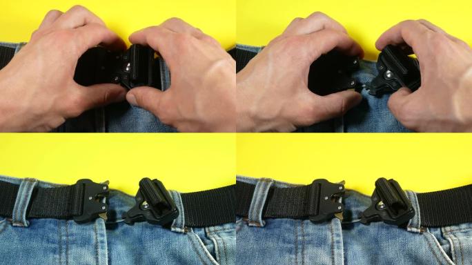 一名男子解开牛仔裤上的黑色布带扣子。现代男士腰带，深色带垫金属扣。
