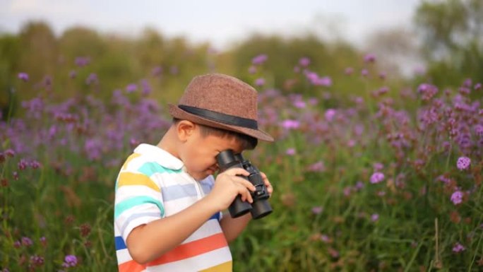 亚洲孩子用双筒望远镜和放大镜在公园和森林里户外学习