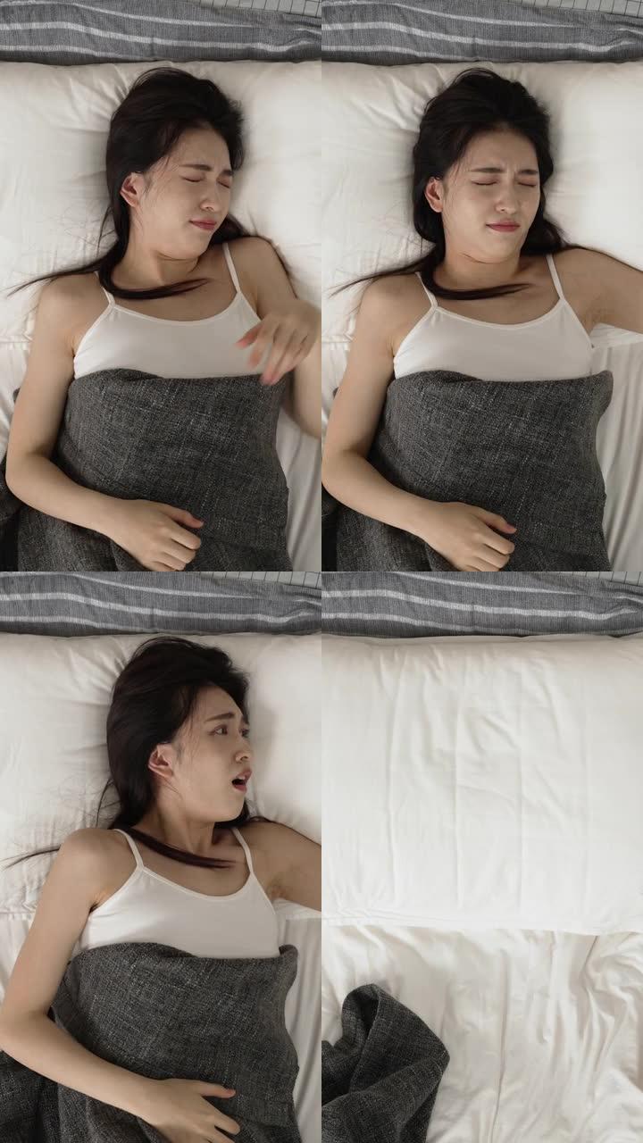 垂直屏幕: 从上方观看睡过头的亚洲日本妇女醒来时发出警报，并以震惊的表情急忙下床，因为她早上在家上班