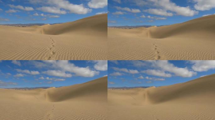 无人机拍摄了沙漠中沙丘上的一对脚印