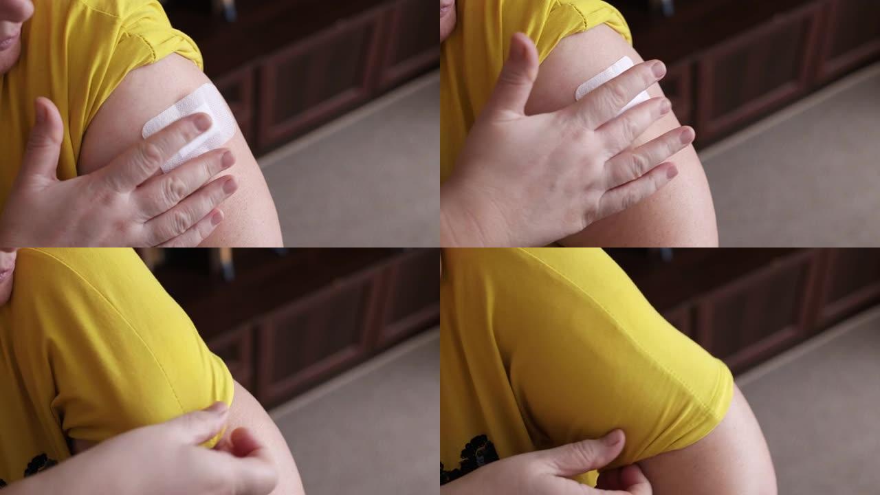 女人在上臂外侧的皮肤上涂抹一个HRT贴片。