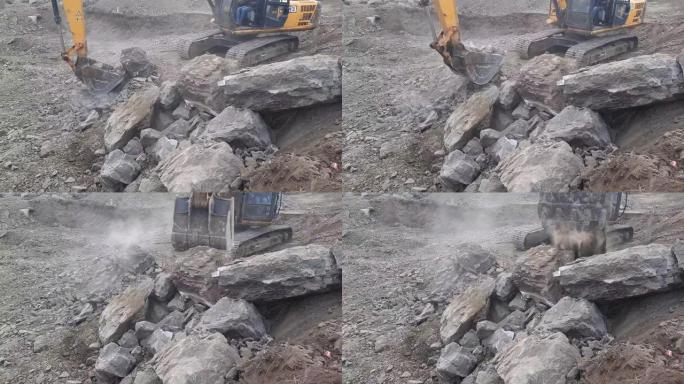 挖掘机的手臂捡起大石头。一种用于新建建筑用地的液压挖掘机工程。