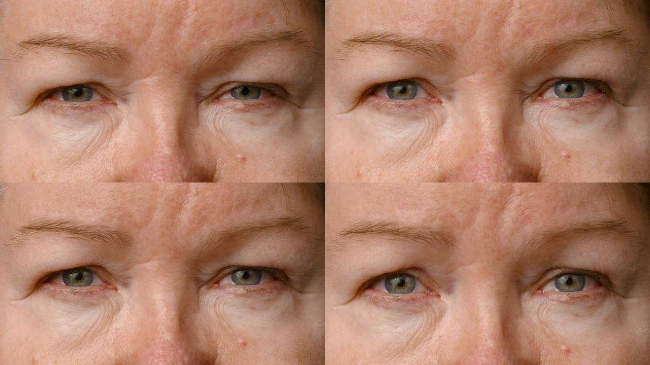 一位老年妇女的特写镜头。那个女人睁开眼睛，看着镜头。老年人的皮肤。高级女人眼睛，皱纹的脸