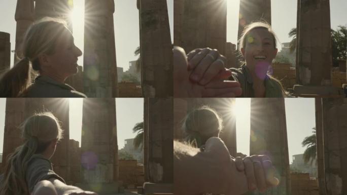 慢动作: 年轻女子牵着男朋友的手带领着埃及美丽的寺庙-女孩向伴侣一起旅行的个人视角