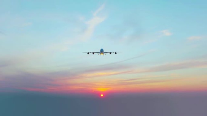 一架商用飞机在日落背景下降落