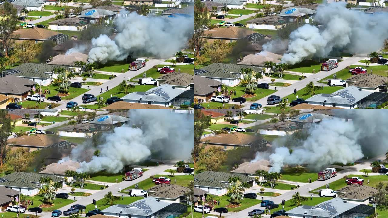 房屋着火的鸟瞰图和消防员在短路导致火花点燃被飓风伊恩风损坏的木质屋顶后扑灭火焰。佛罗里达郊区的家庭灾