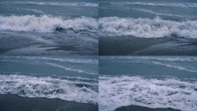 深蓝色背景下的海浪席卷海滩。危险的自然概念。