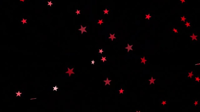 爆炸的红星五彩纸屑在黑色的背景。节日视频效果。3 d动画。