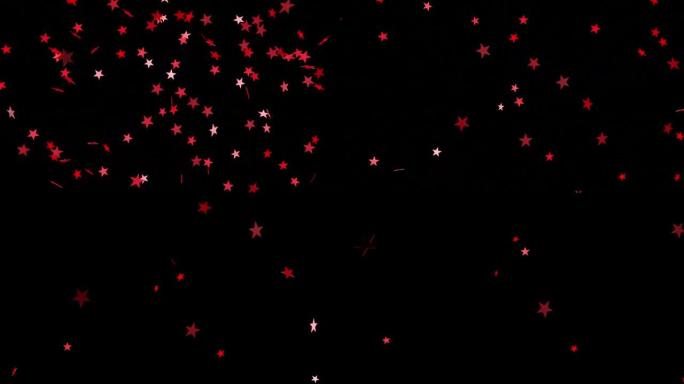 爆炸的红星五彩纸屑在黑色的背景。节日视频效果。3 d动画。