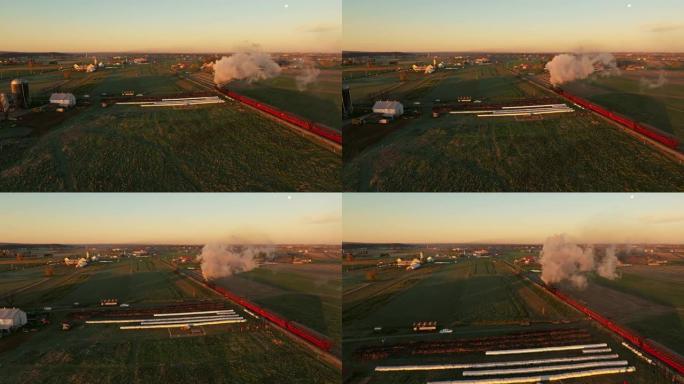 从蒸汽机的上下和后面看无人机，在秋天的早晨，日出时吹着大量烟雾穿过农田