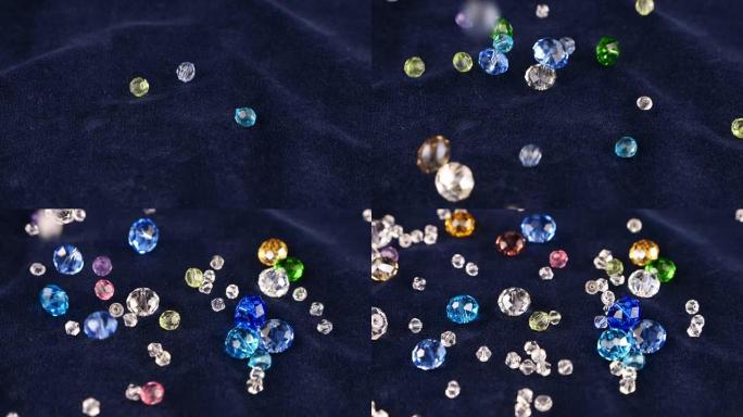 多色透明珠宝水晶和水晶落在蓝色天鹅绒上。慢动作。
