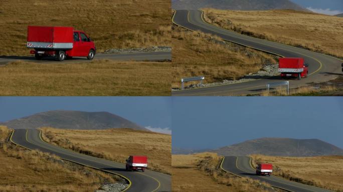 红色小型货车在许多弯道的道路上行驶