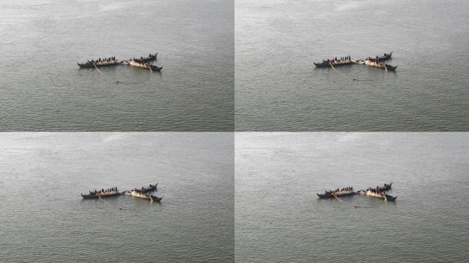 清晨，小船上的渔民将大网从水中抬起
