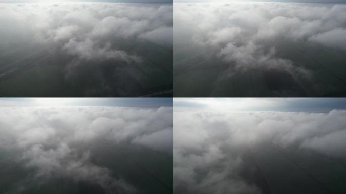 在田野上方的云层中飞行。飞入云层的摄像机视图。进入云层。相机运动轻轻地下降。版本8