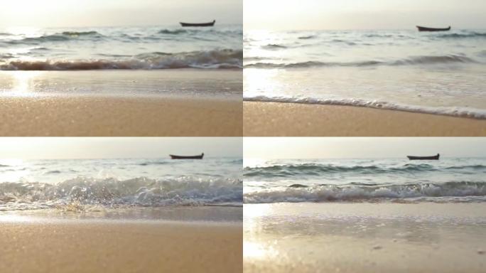 海滩上的小水浪和背景中的小船的风景镜头
