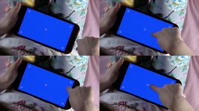 智能手机在儿童手中，显示屏背光并带有蓝色指示。