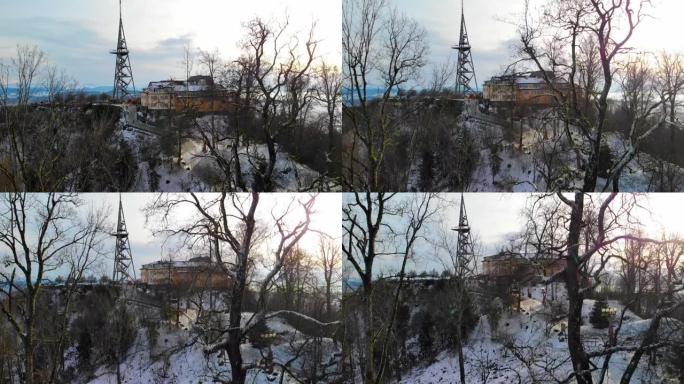 冬季下午朦胧的Uetliberg观景塔的下降无人机视图。