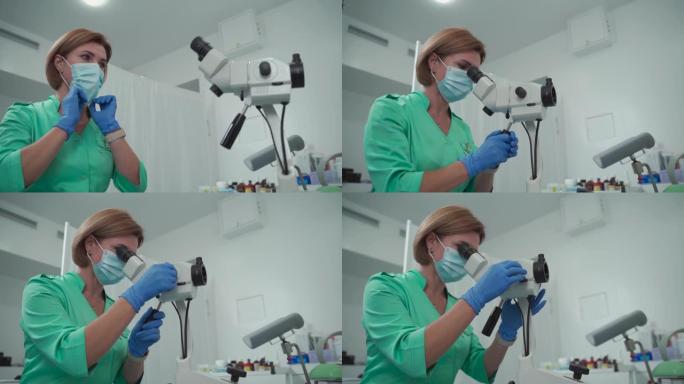 宫颈癌的预防和诊断。成熟的女医生在现代妇女健康诊所的ginigological办公室使用阴道镜显微镜