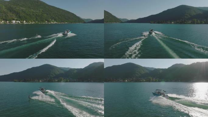 在原始平静的湖上，由摩托艇拉动的男子滑水的空中无人机拍摄