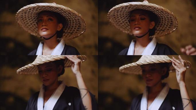 一个穿着和服的女人触摸她的竹帽的特写镜头