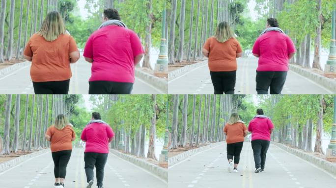 超重夫妇在公园慢跑的后视图