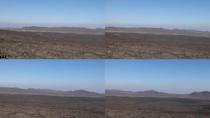 沙特阿拉伯西北部哈拉特·海巴尔地区贾巴尔·Qidr黑色熔岩火山场的景色