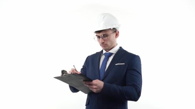 一位年轻的工程师穿着西装，戴着慢动作的安全帽，会为项目做重要的计划笔记或待办事项。科学家和工程师的概