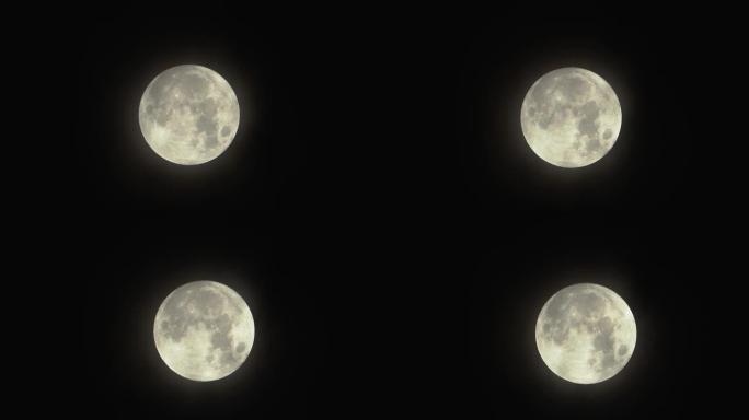 满月升起的月亮设定时间流逝，满月从左向右越过，在晴朗的天空中没有云，满月带有移动的乌云。夜间延时。没