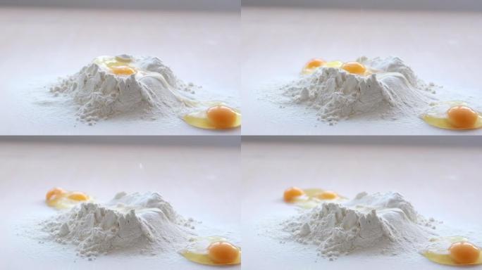 烘焙烹饪美味的烹饪甜点鸡蛋被扔进面粉中，它们失败了，并向侧面滚动视频开始于一个鸡蛋从面粉火山中慢慢滚