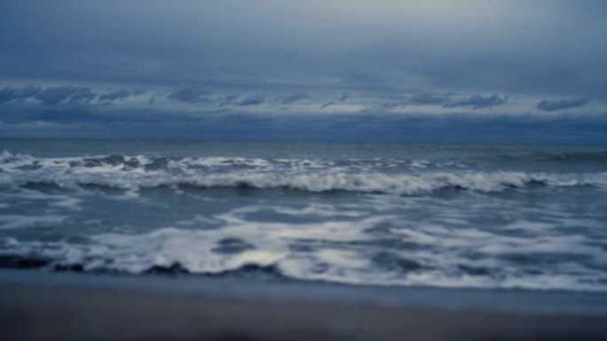 海浪席卷风景海滩。黑暗的海潮水撞击自然海岸。