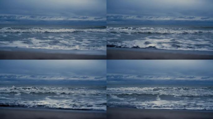 海浪席卷风景海滩。黑暗的海潮水撞击自然海岸。