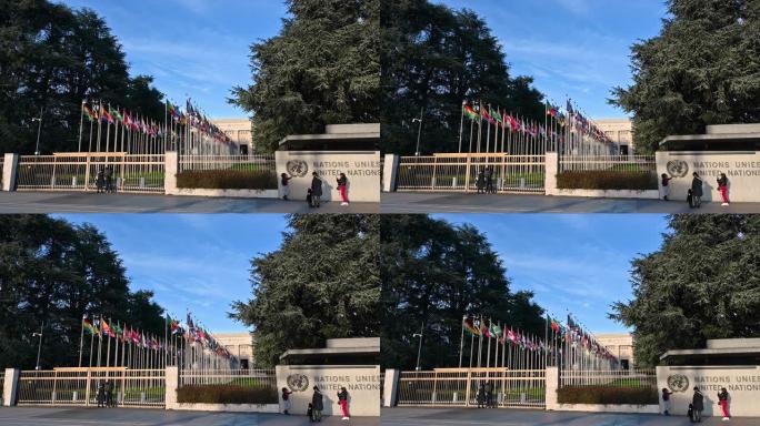 2023年1月，瑞士日内瓦。这是联合国总部的漂亮慢镜头。人们在该组织的标志旁拍照留念。