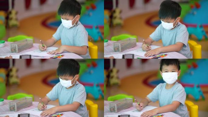 学校美术课上的亚洲男孩色彩和绘画